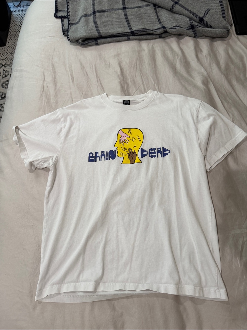 Brain Dead White Tee with Yellow Head Graphic and Navy Text